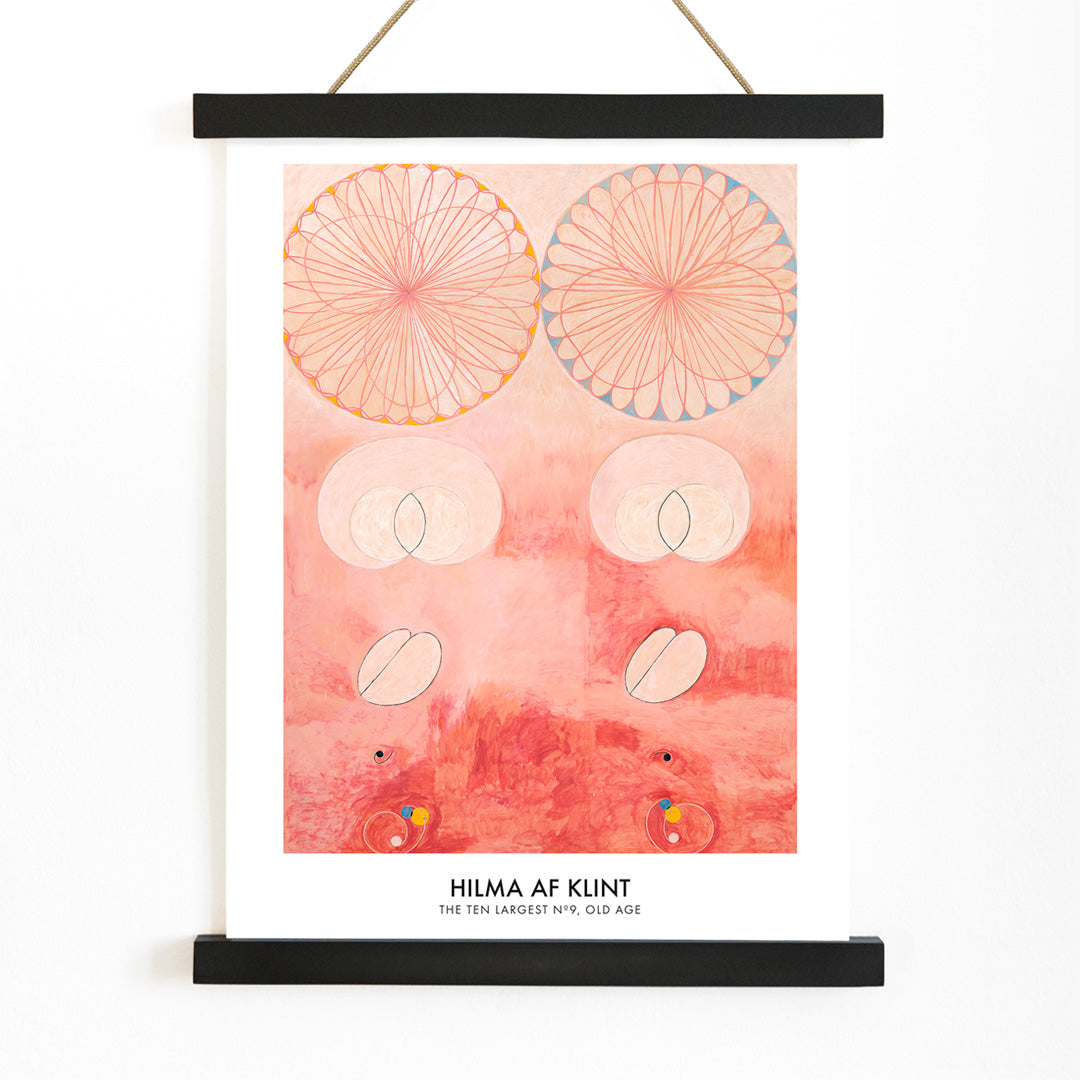 Abstract geometric and circular patterns in pink and orange from The Ten Largest Old Age by Hilma af Klint art poster, with wooden magnetic frame on white background