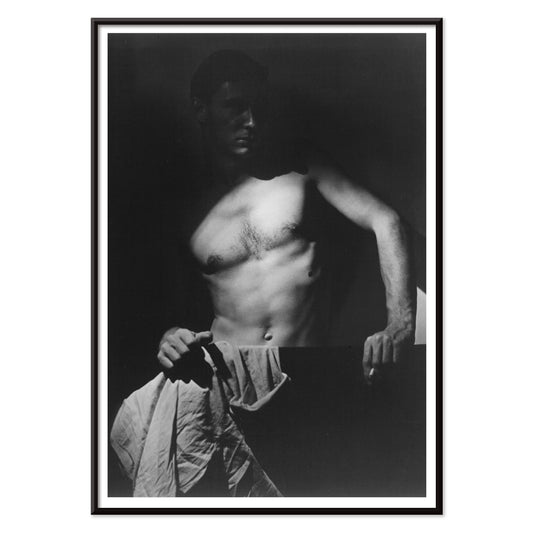 Shirtless man holding towel in dramatic lighting Max After Surfing by Olive Cotton wall art photography poster, with black aluminium frame on white background