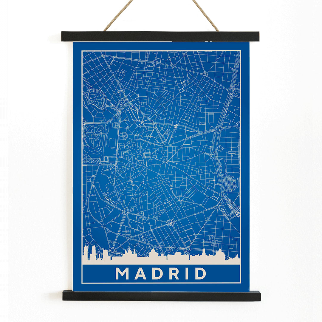 Minimalist Madrid Map by Artist Name blue and white city layout with silhouettes and street details poster, with wooden magnetic frame on white background