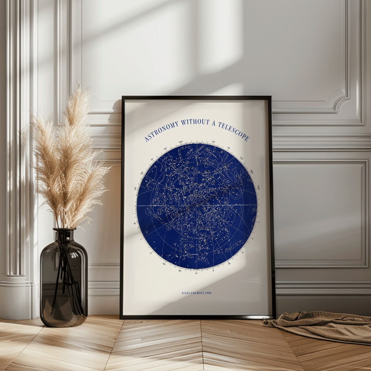 Star map and poster of constellations titled Astronomy without a Telescope by Elias Colbert featuring celestial star chart in blue, framed and displayed in home decor