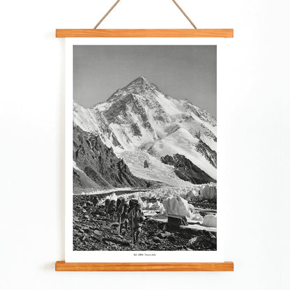 Black and white photo by Vittorio Sella of mountaineers trekking toward K2 over the Godwin Austen glacier titled Le pic K2 vue prise du glacier Godwin Austen, with wooden magnetic frame on white background