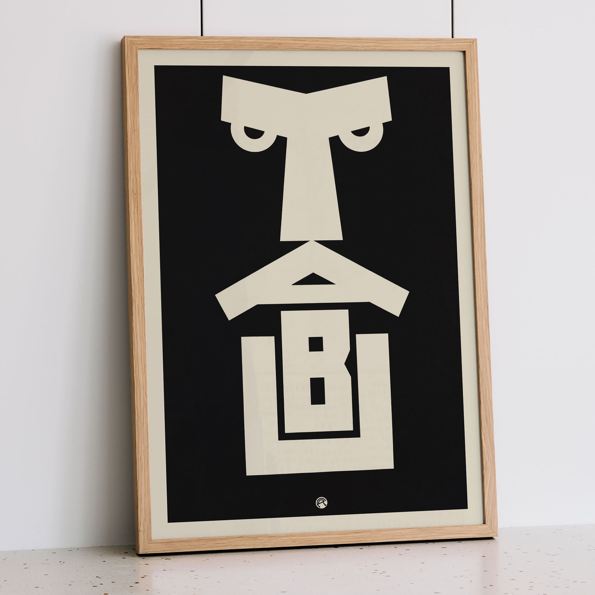 Julius Klinger Tabu poster with bold black and cream abstract geometric face in minimalist vertical design, framed and displayed in modern living room decor