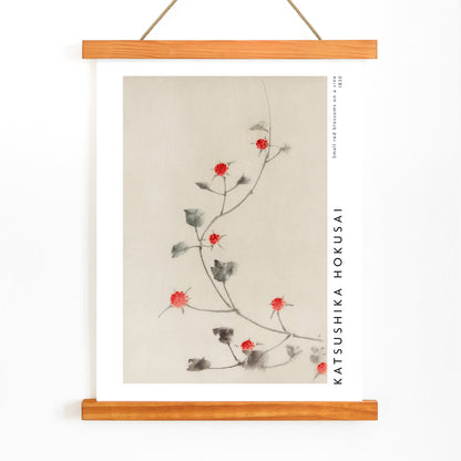 Small Red Blossoms on a Vine artwork by Katsushika Hokusai featuring delicate red flowers and green leaves on a light background, with wooden magnetic frame on white background