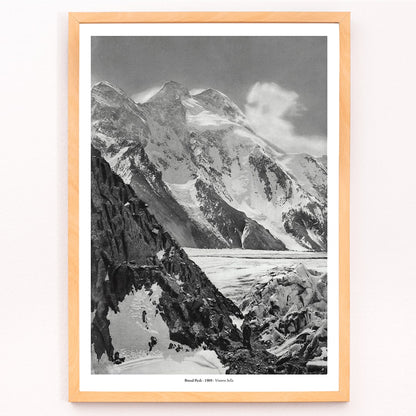 Black and white photograph and poster of Broad Peak by Vittorio Sella showing snow covered mountains and mountaineers climbing amidst rocky terrain and glacier, framed and displayed in modern living room decor