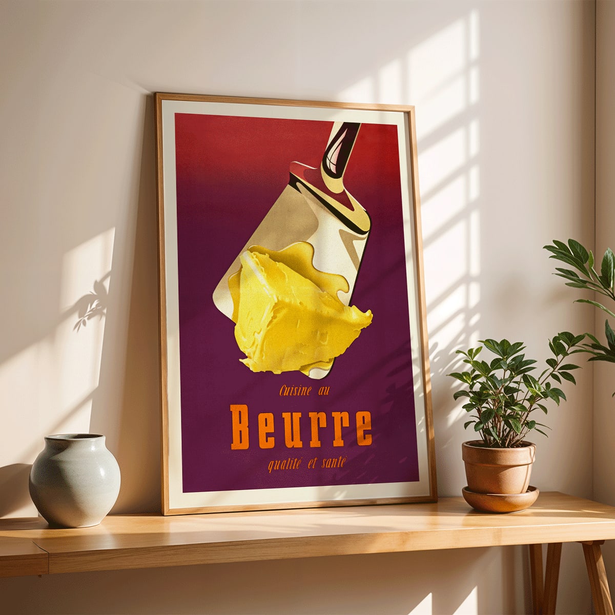 Vintage butter advertisement art by Donald Brun featuring a spatula and bold French text, framed and displayed in modern living room decor