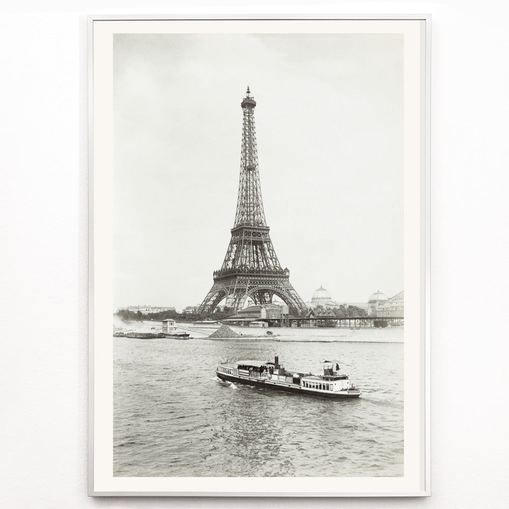 Closeup detail of Black and white photograph and poster of the Eiffel Tower in Paris with a vintage boat on the Seine river wall decor artwork
