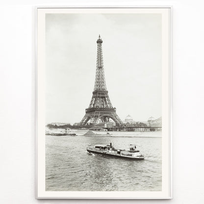 Closeup detail of Black and white photograph and poster of the Eiffel Tower in Paris with a vintage boat on the Seine river wall decor artwork