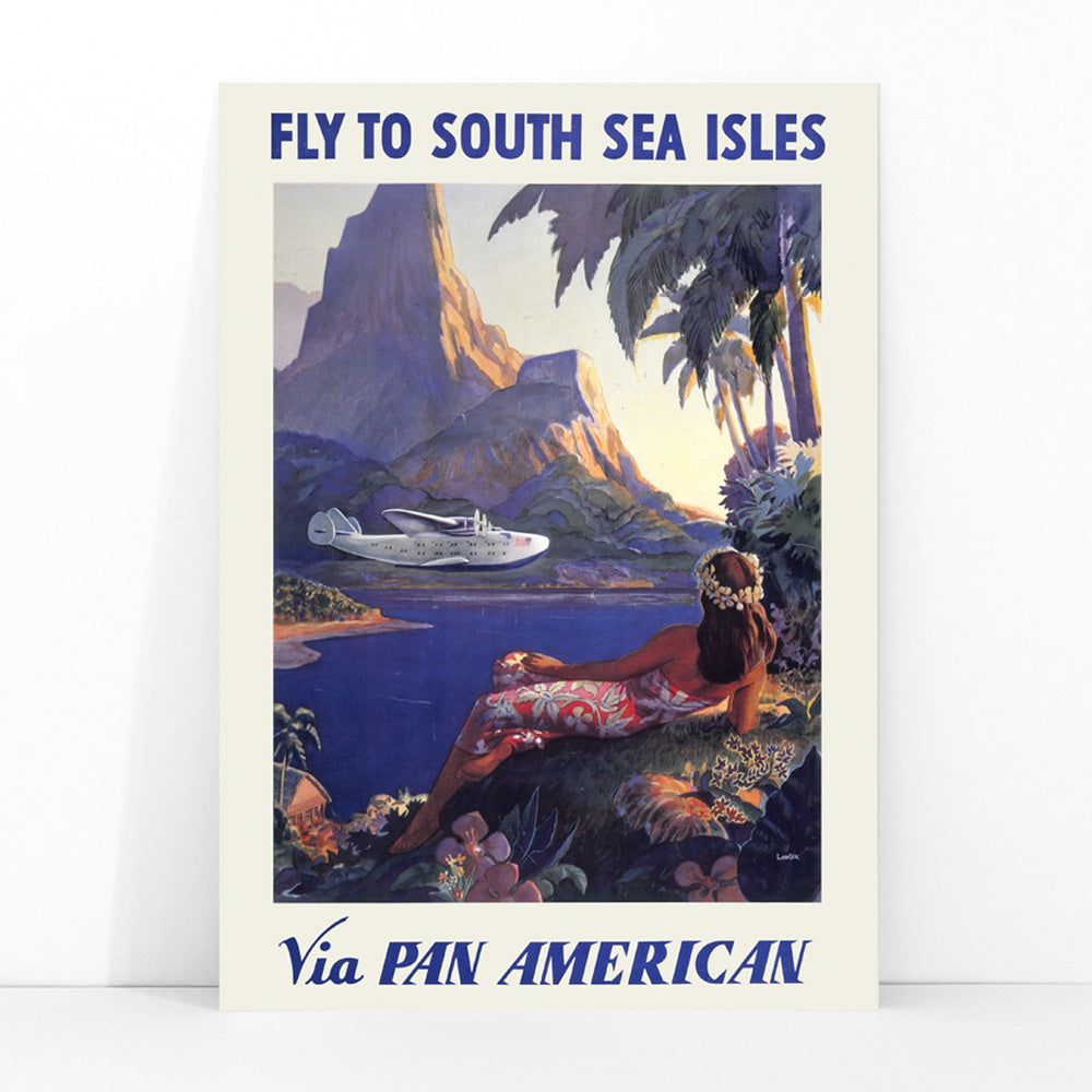 Vintage travel poster of a woman in a floral dress on a tropical island with a Pan American seaplane by Paul George Lawler, framed and displayed in modern living room decor