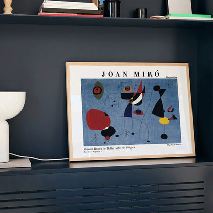 Exhibition poster of abstract artwork Woman and Bird at Night by Joan Miro with colorful shapes on a blue background, framed and displayed in modern living room decor