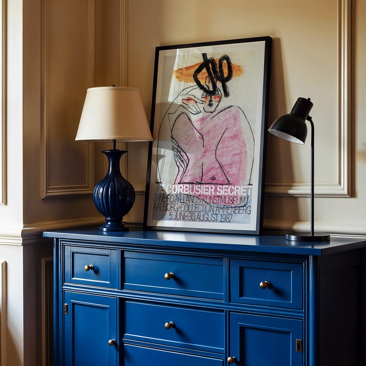 Secret Ahrenberg Collection Exhibition poster by Le Corbusier featuring abstract art with bold lines and vivid colors, framed and displayed in modern living room decor