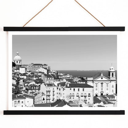 Black and white landscape of Lisbon Old City with historic architecture rooftops and distant sea view poster by Picture 2, with wooden magnetic frame on white background