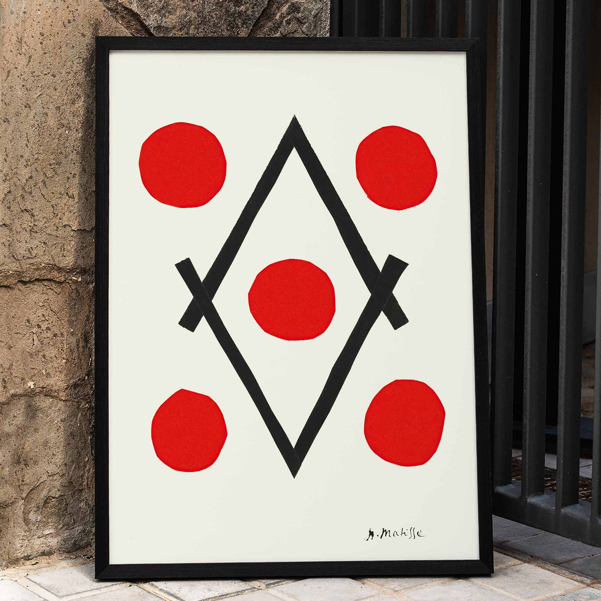 Henri Matisse Losange poster with five red circles around intersecting black lines forming a diamond on white ground, framed and displayed in home decor