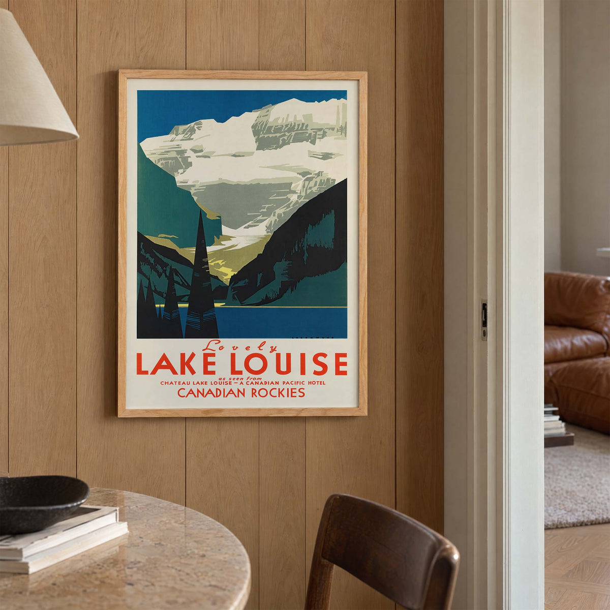 Lovely Lake Louise Canadian Pacific poster with snowy Canadian Rockies, pine trees and blue alpine lake in Canada, with wooden magnetic frame on white background