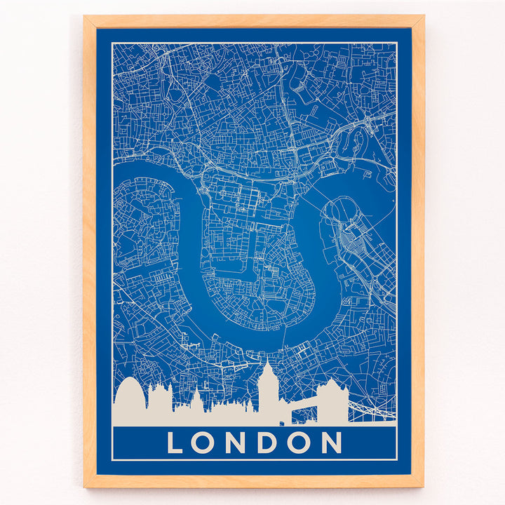 Minimalist London map artwork poster with blue background white map details by artist Anonymous featuring major landmarks, framed and displayed in modern living room decor