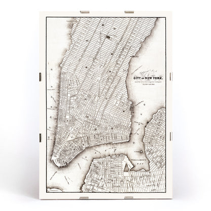 Vintage map of New York City showing detailed streets and layout from Library of Congress Geography and Map Division titled Map of the City of New York, framed and displayed in modern living room decor