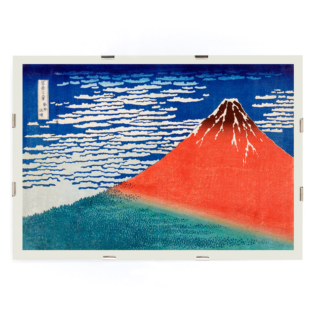Fine Wind Clear Morning by Katsushika Hokusai poster showing red Mount Fuji under blue sky with white clouds, framed and displayed in modern living room decor
