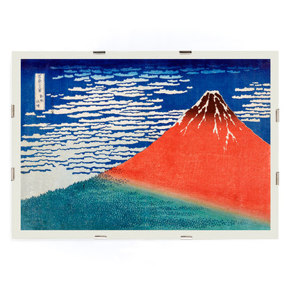 Fine Wind Clear Morning by Katsushika Hokusai poster showing red Mount Fuji under blue sky with white clouds, framed and displayed in modern living room decor