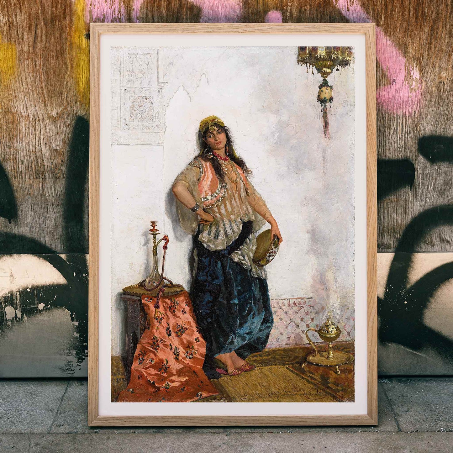 Oriental dancer painting by Cesare Biseo featuring a woman in traditional attire with a hookah ornate backdrop table and lamp, framed and displayed in home decor
