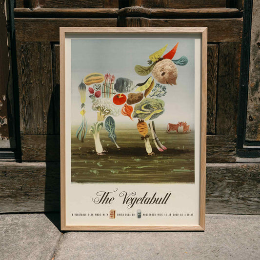 The Vegetabull by Lewitt-Him painting and poster showing a bull made of vegetables on grass background, framed and displayed in home decor