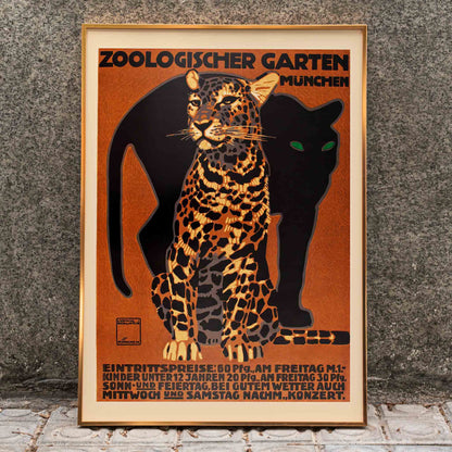 Leopard and black panther poster for Zoologischer Garten München by Ludwig Hohlwein featuring bold text artwork, framed and displayed in home decor