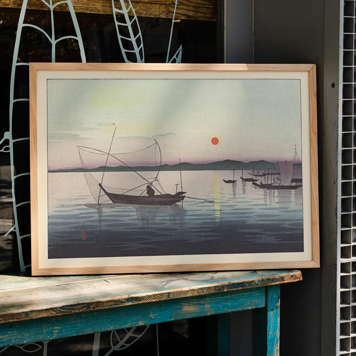 Traditional Japanese boats on calm water at sunset with mountains artwork by Ohara Koson, framed and displayed in home decor