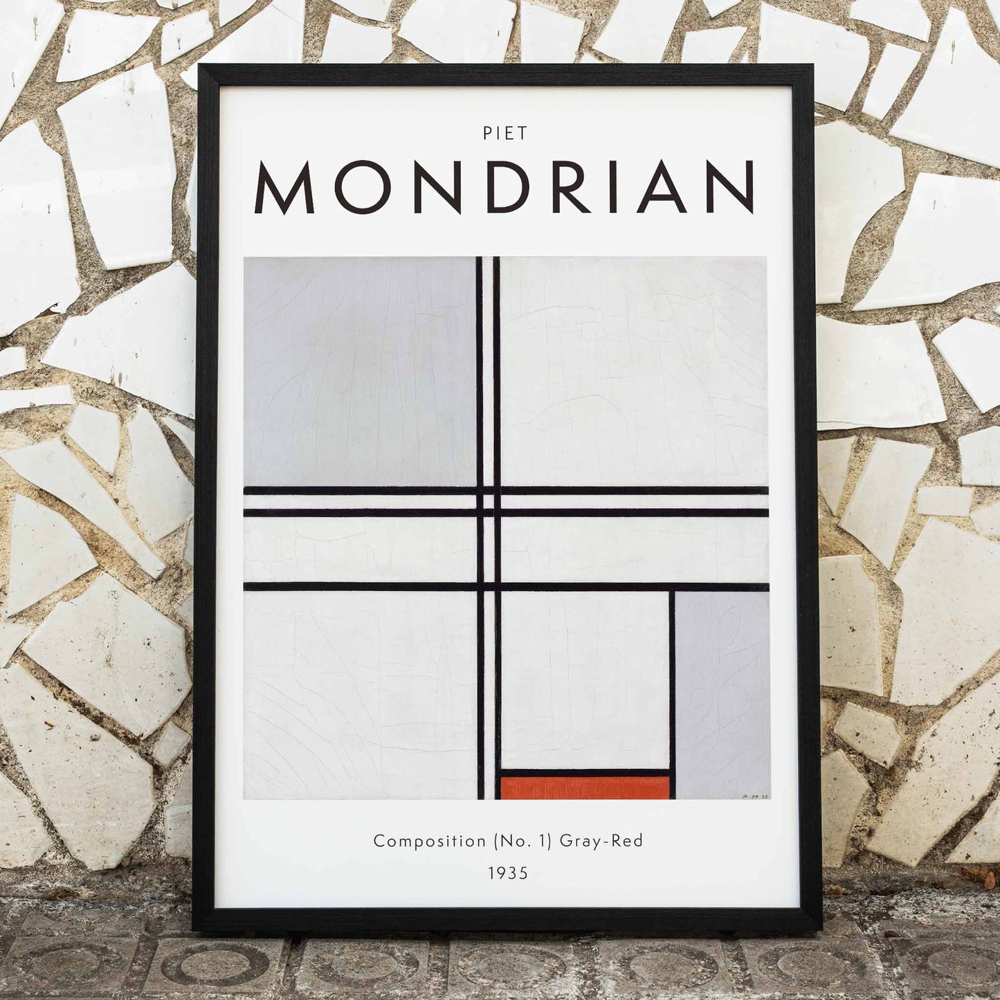 Geometric abstract artwork poster with black lines and color blocks by Piet Mondrian Composition No 1 Gray-Red, framed and displayed in home decor