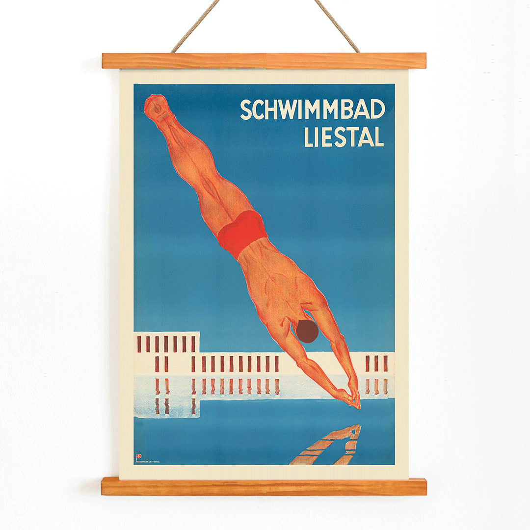 Schwimmbad Liestal poster by artist showing a man diving into a pool with a modern building in the background, with wooden magnetic frame on white background