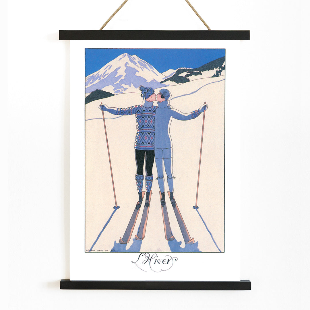 Two skiers kissing in snowy mountain landscape L Hiver by George Barbier vintage poster artwork, with wooden magnetic frame on white background