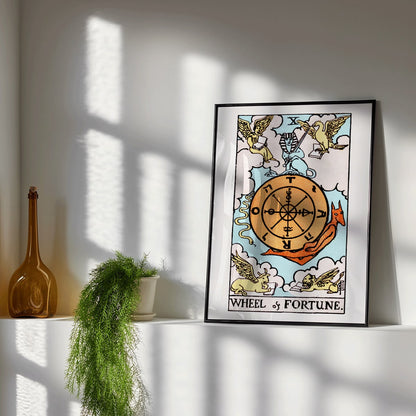 Tarot The Wheel Of Fortune by Rider Waite featuring a mystical wheel surrounded by mythical creatures poster and card artwork, framed and displayed in modern living room decor