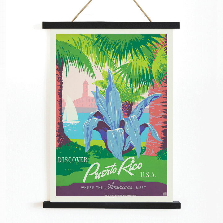 Discover Puerto Rico travel poster by WPA featuring vibrant tropical scenery tropical plants a sailboat and a historic fort in colorful art, with wooden magnetic frame on white background