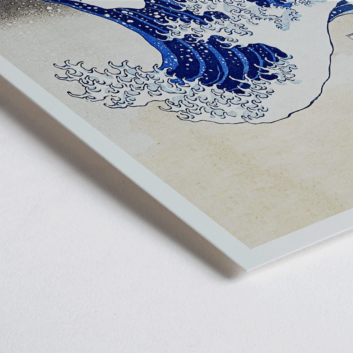 Closeup detail of The Great Wave off Kanagawa by Katsushika Hokusai showing a dramatic large wave threatening small boats with Mount Fuji in the background